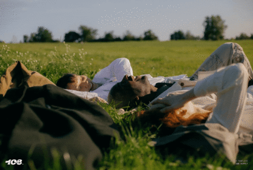 Designers in a serene field setting, ideal for mockup templates or graphic inspiration related to nature relaxation and creative outdoor design projects.