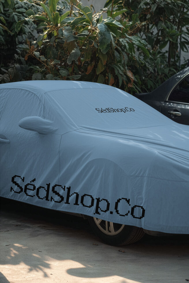 Car cover mockup with branding on light blue fabric draped over sedan in driveway