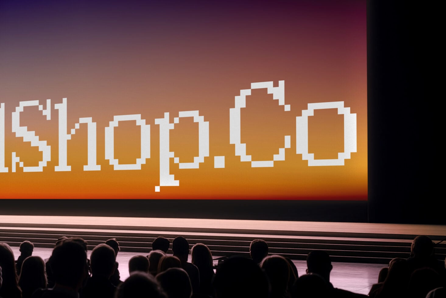 Retro pixel art text glowing over warm sunset gradient on cinema screen with audience silhouettes below