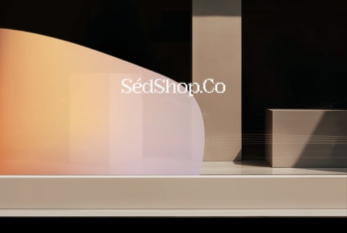 Minimal product display with geometric boxes on beige shelf, warm gradient backdrop, modern branding mockup
