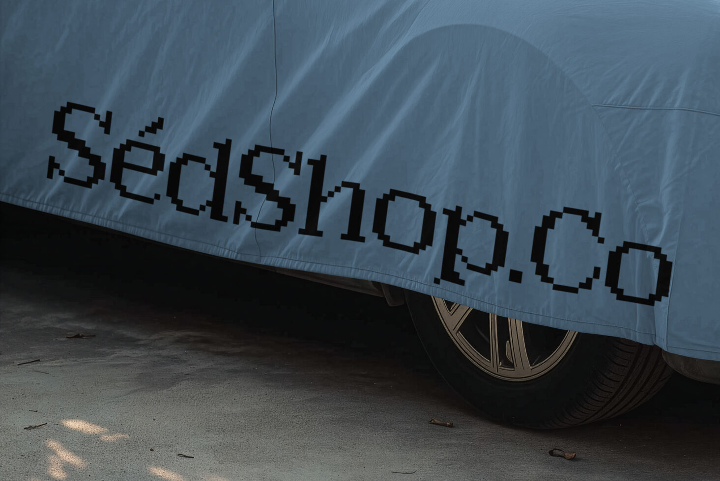 Retro pixel font text on blue car side panel with wheel visible below