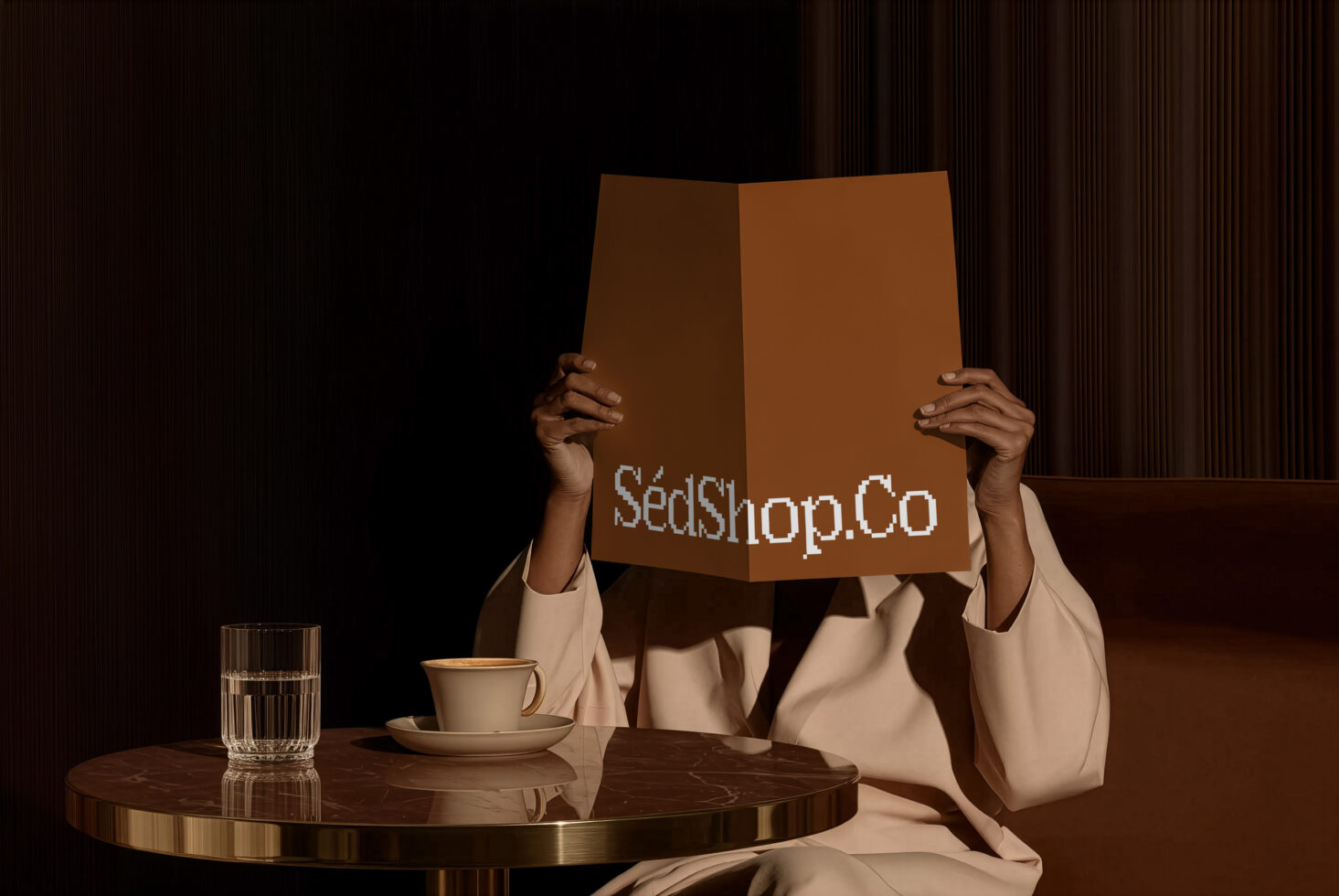 Person holding open cardboard box with SedShop.Co branding over head at table with coffee cup