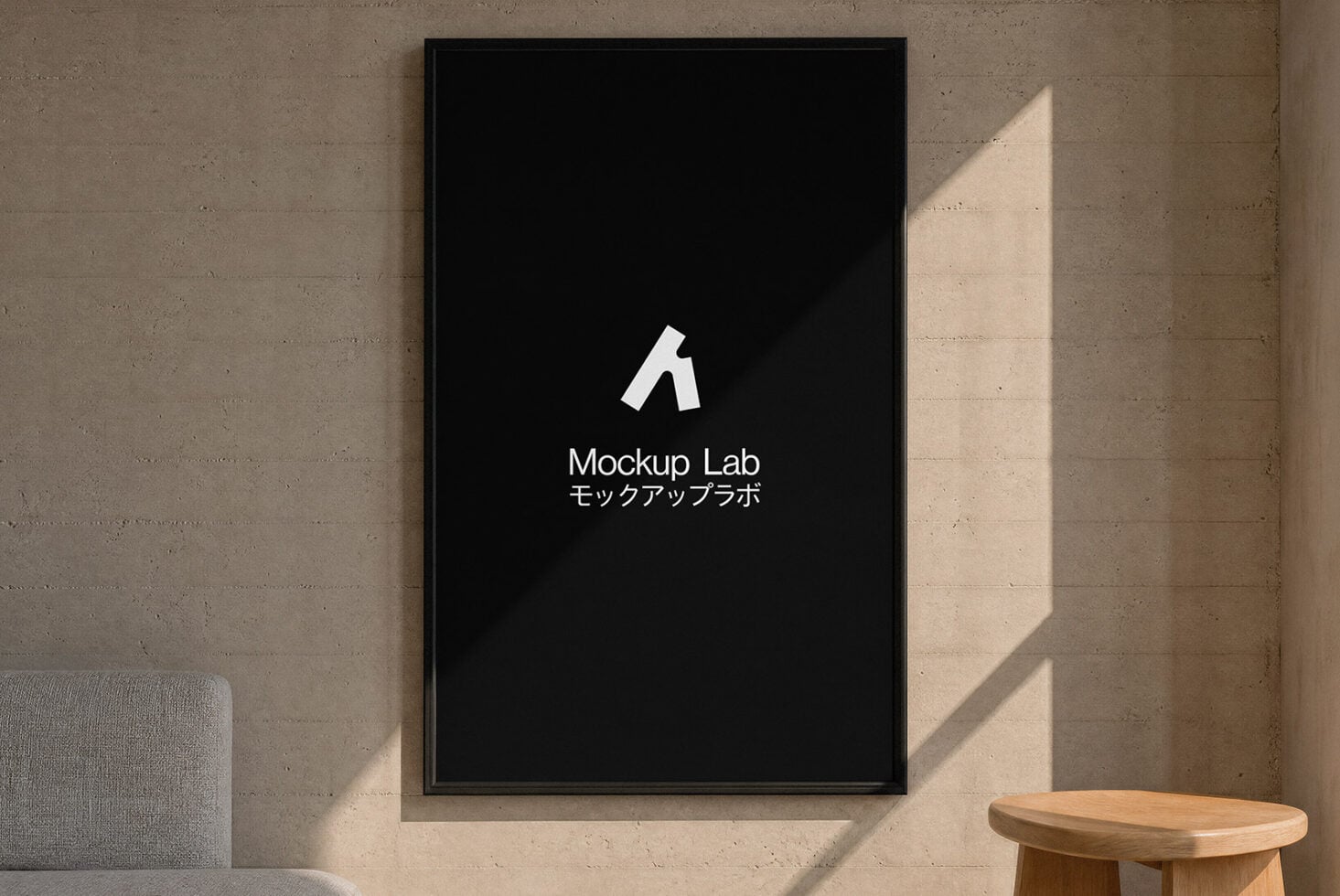 Framed poster mockup on concrete wall with natural light, wood table in corner