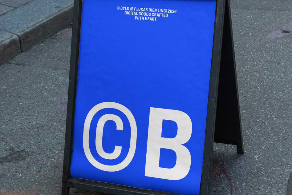 Bright blue A-frame sign with cream colored "CB" letters, copyright text visible at top