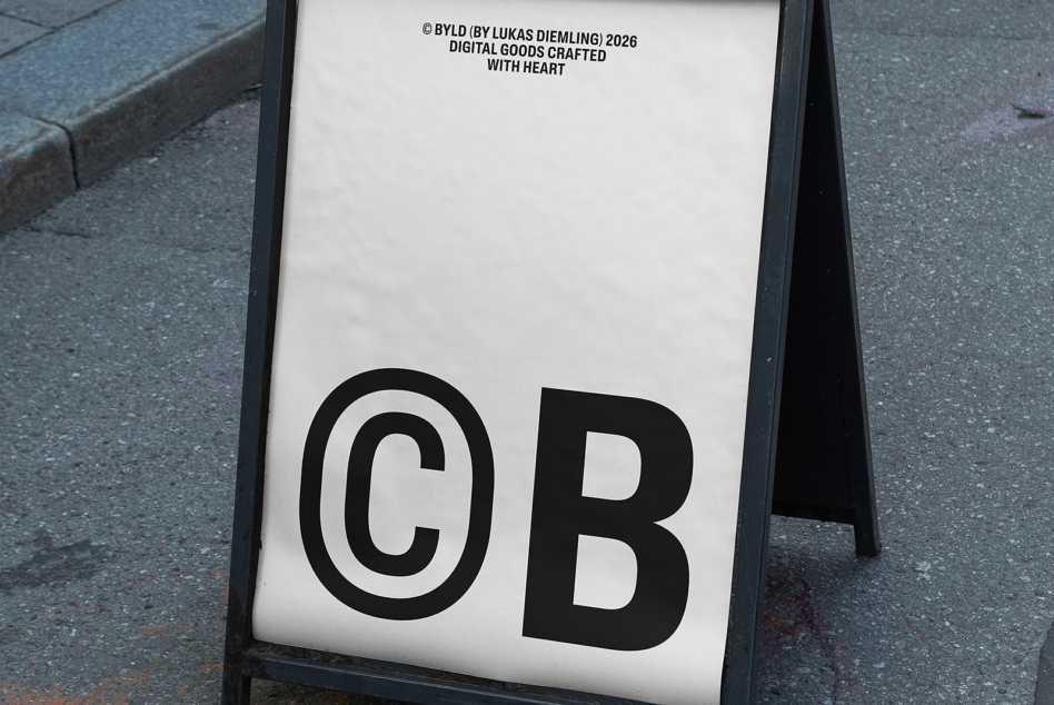 Black folding A-frame sign mockup on pavement with copyright text