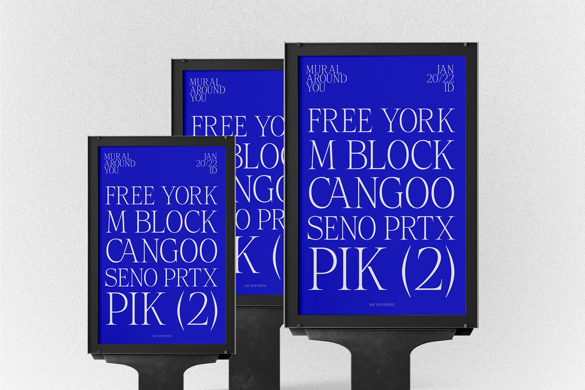Street poster mockup with three black frames displaying bold blue typography layouts in different sizes