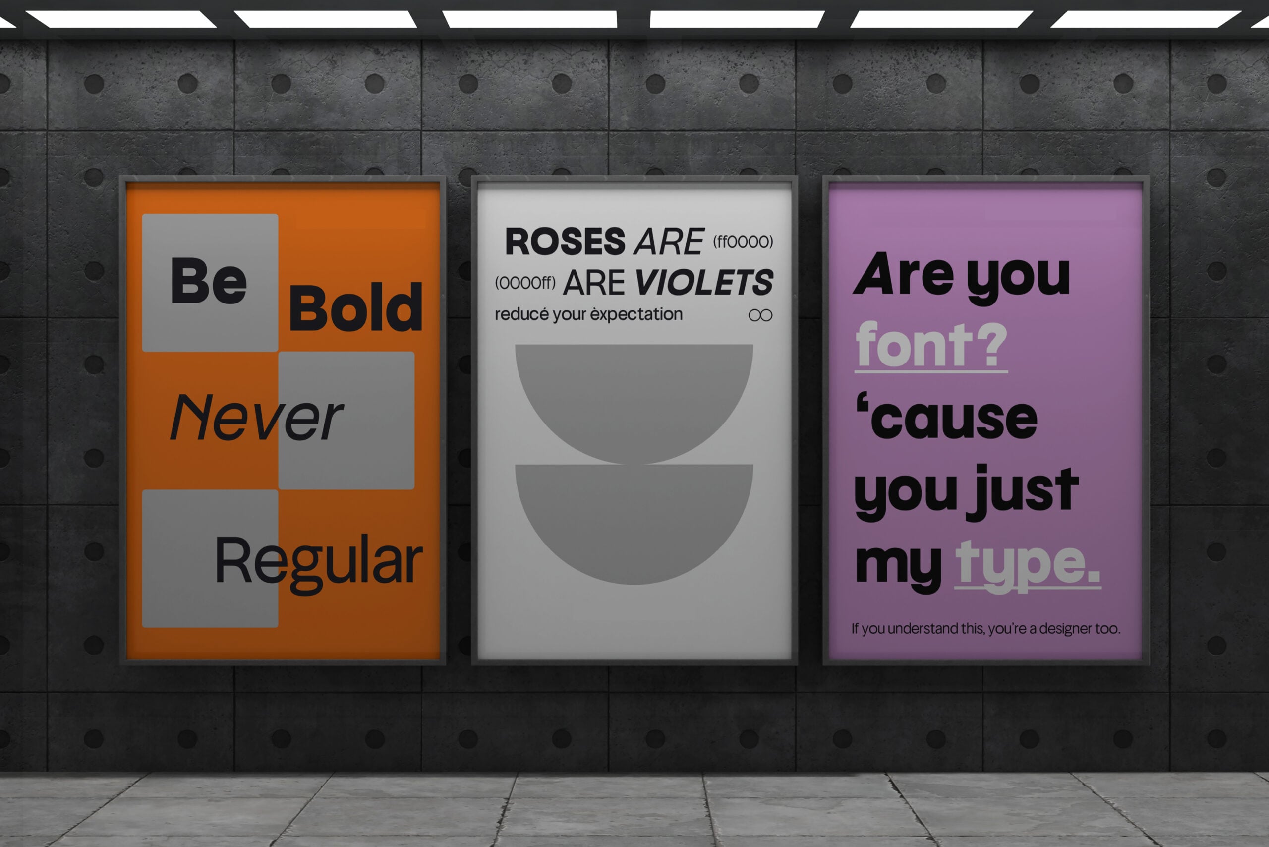 Three framed posters on industrial wall: orange bold typography, minimalist circles, purple font humor