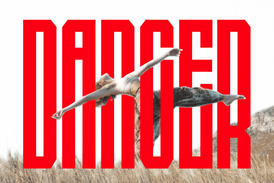 Shirtless guy diving horizontally across bold red block letters over desert landscape