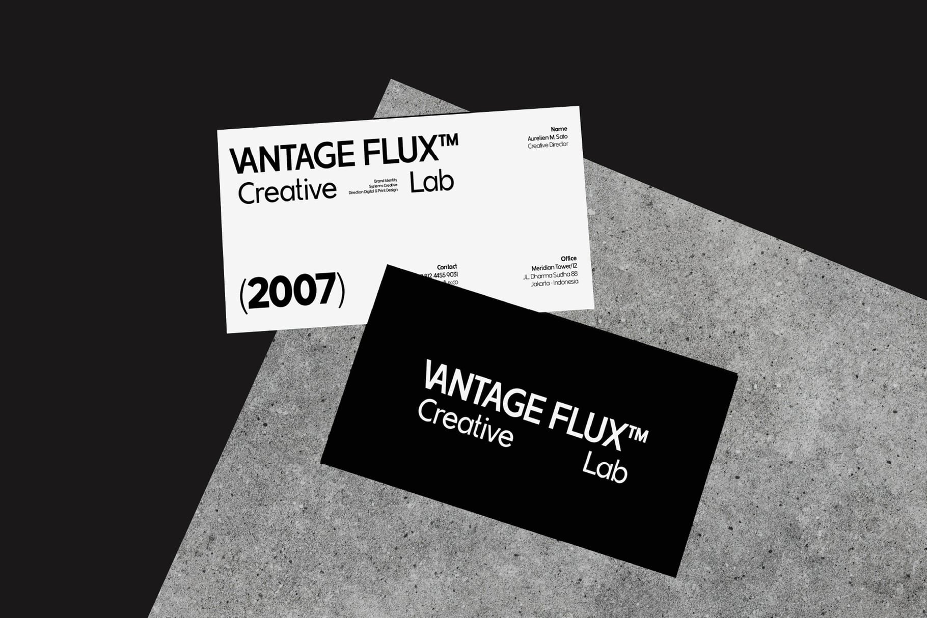 Vantage Flux Creative Lab business cards from 2007 on concrete surface mockup
