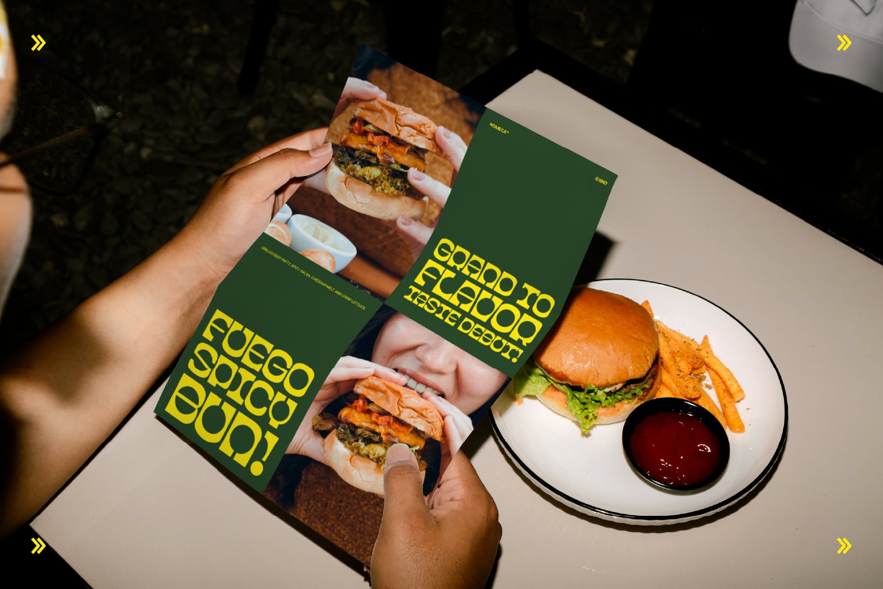 Green burger menu mockup with bold yellow type, hands holding flyers next to plated burger with fries
