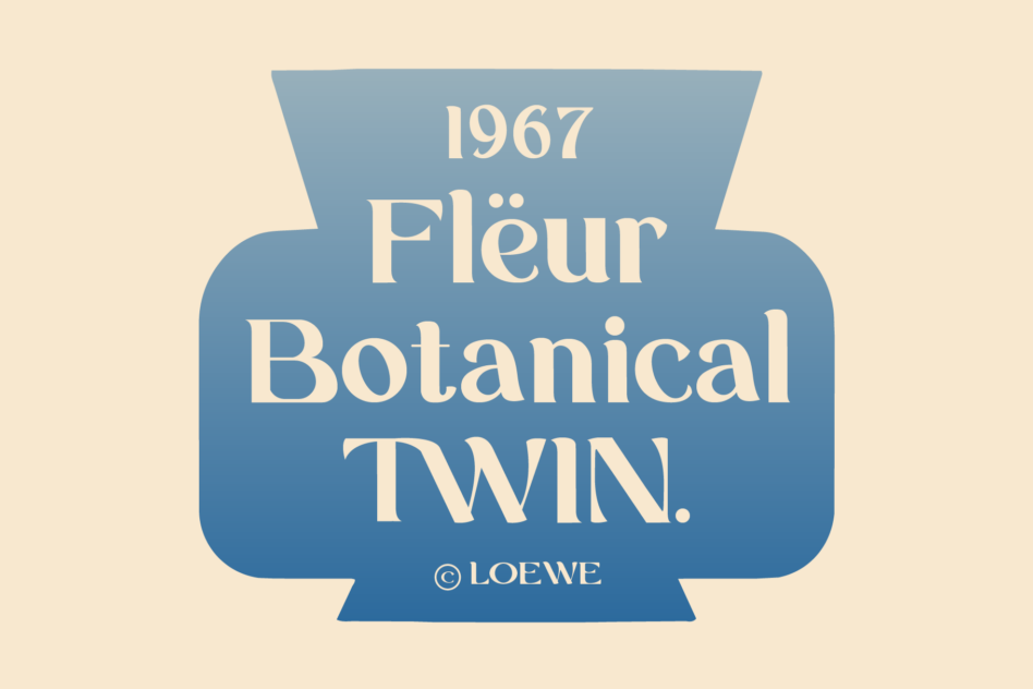 Vintage blue badge with cream serif typography reading 1967 Fleur Botanical TWIN, Loewe copyright mark below