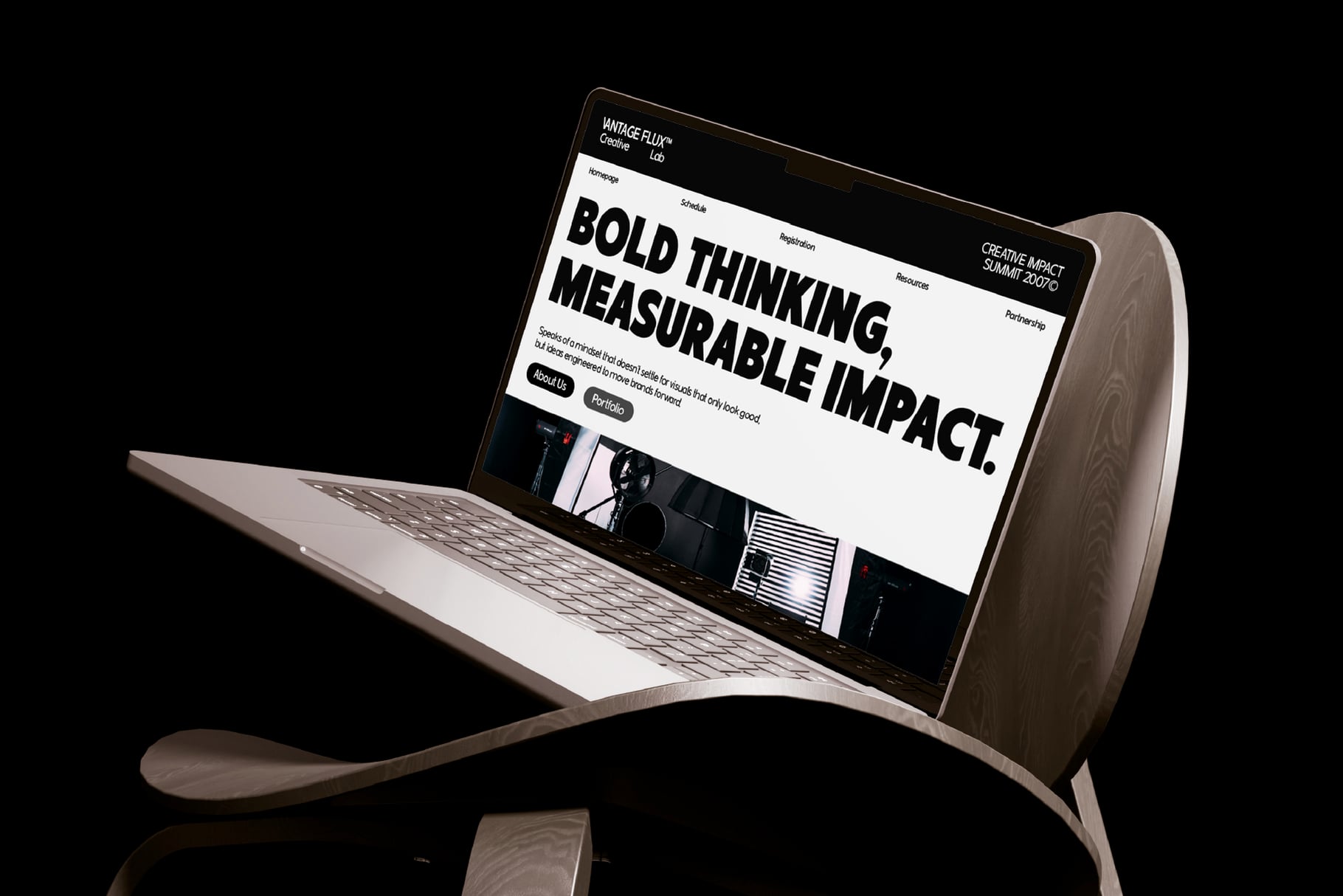 Curved wooden monitor displaying website with bold typography reading "bold thinking, measurable impact"