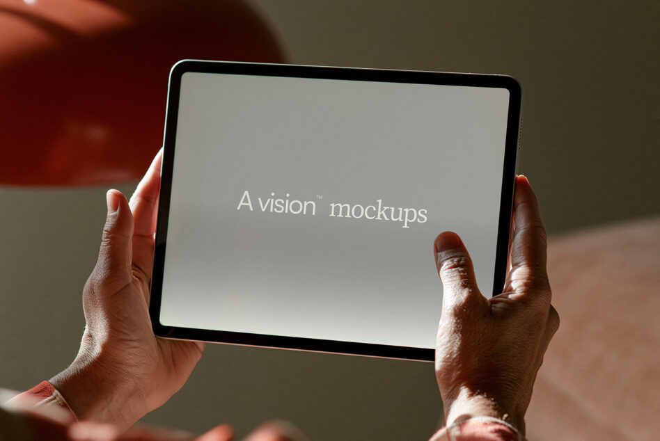 Hands holding tablet in landscape mode displaying text on neutral screen