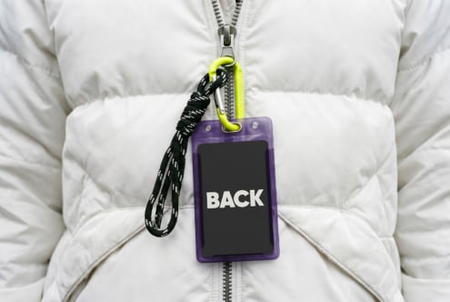 Purple ID badge mockup on white puffer jacket with neon carabiner lanyard