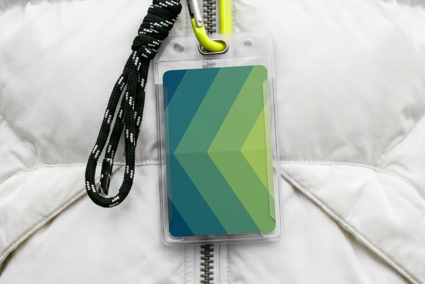 ID badge mockup with teal to lime gradient chevron design on white puffer jacket background