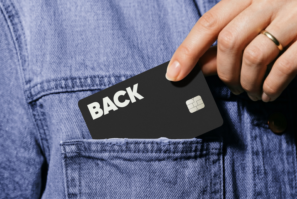 Black credit card mockup pulled from denim jacket pocket with chip visible