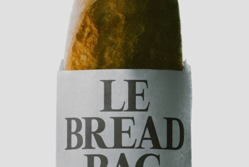 Le Bread Bag mockup showing crinkled paper wrapping with serif typography on loaf