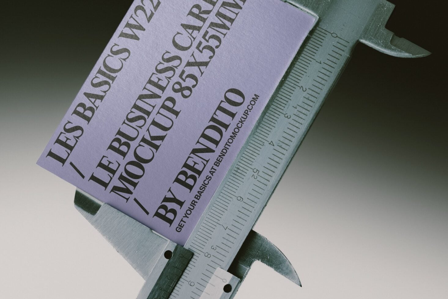 Lavender business card mockup held in metal calipers for precise size measurement