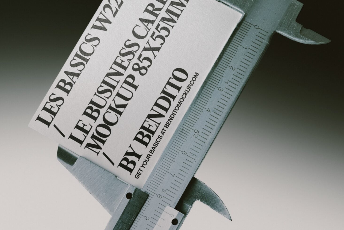 White label with black typography held by green digital caliper measuring device
