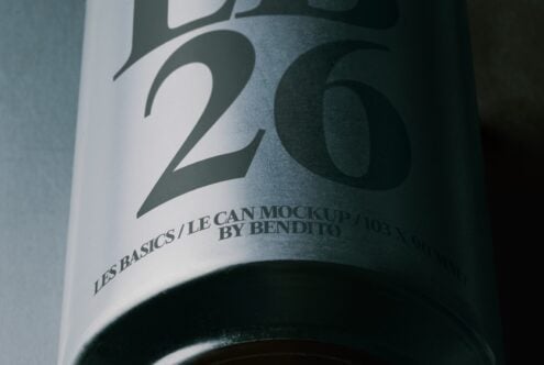 Close-up of minimalist beverage can label with bold typography, green tones, designer branding visible