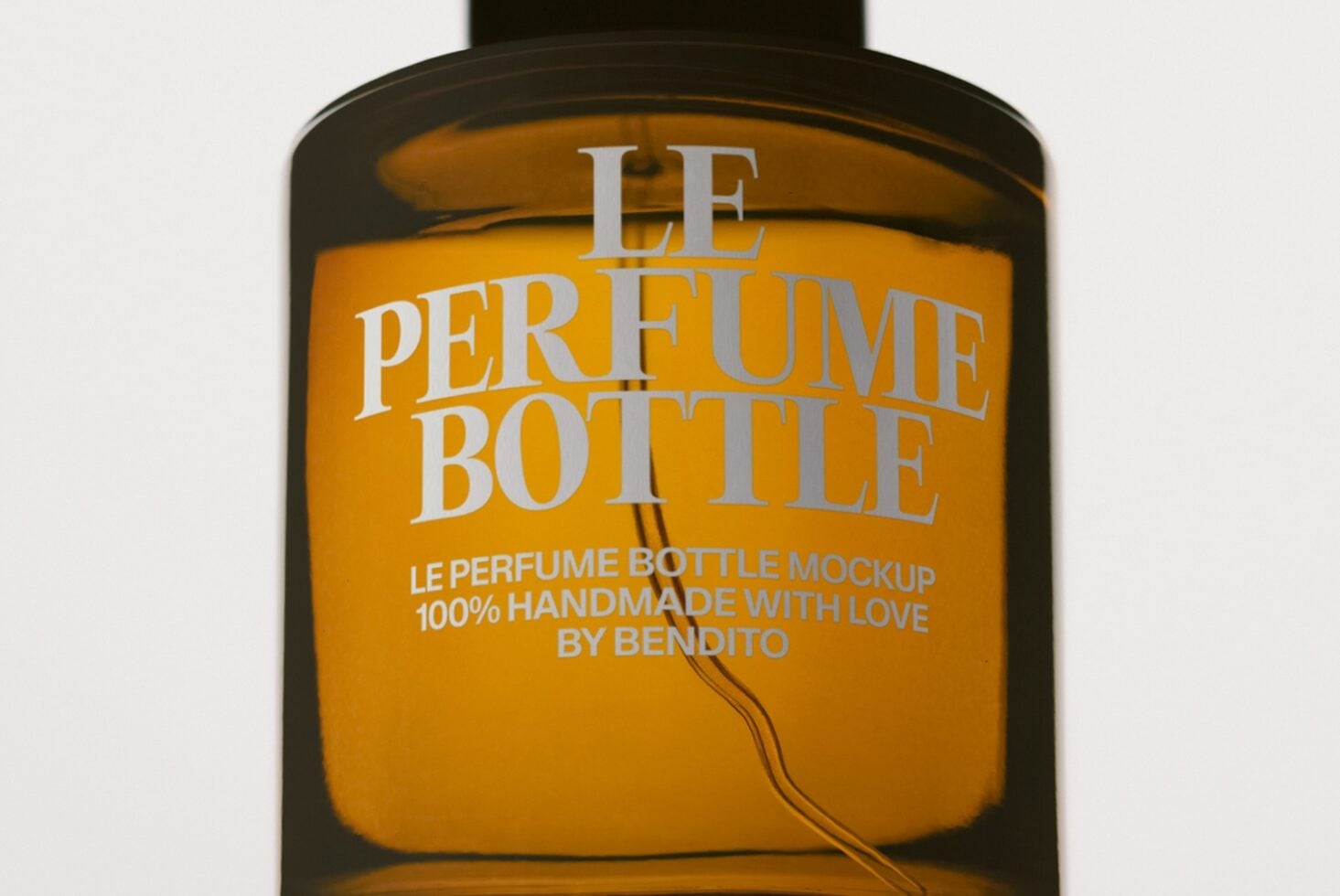Luxury perfume bottle mockup with gold label on dark glass container showing customizable branding space