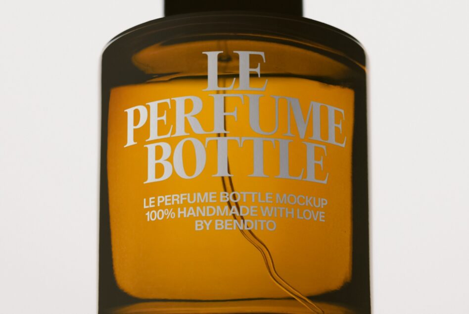 Luxury perfume bottle mockup with gold label on dark glass container showing customizable branding space