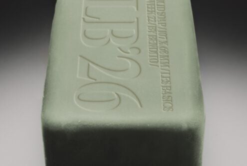 Embossed soap bar mockup with debossed text on pale green surface