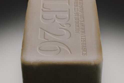 Embossed soap bar with organic branding, cream colored top with deep carved text details