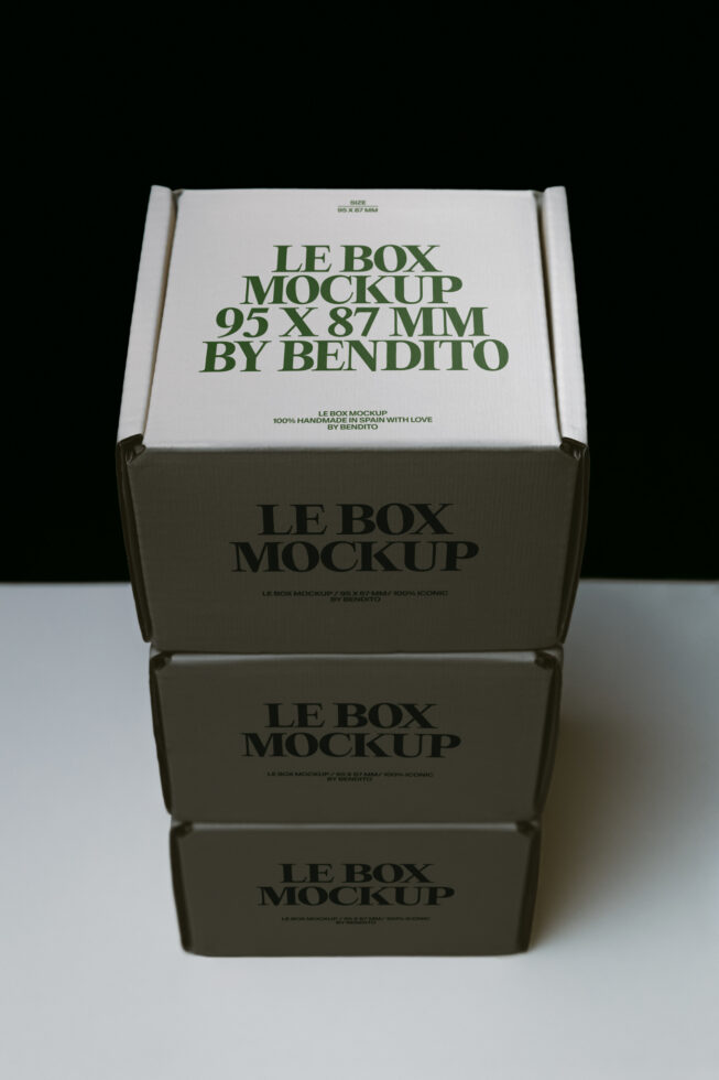 Stacked kraft boxes with white lid showing green typography mockup from above