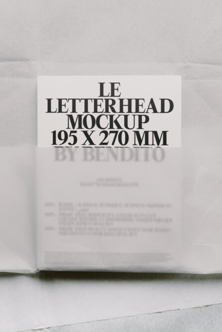 Cream letterhead mockup standing upright with bold serif typography on minimal concrete background