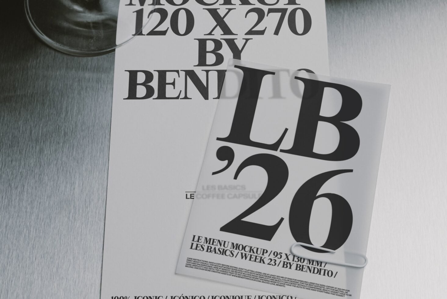 Stacked magazine covers with bold serif typography on brushed metal surface, cup visible top left