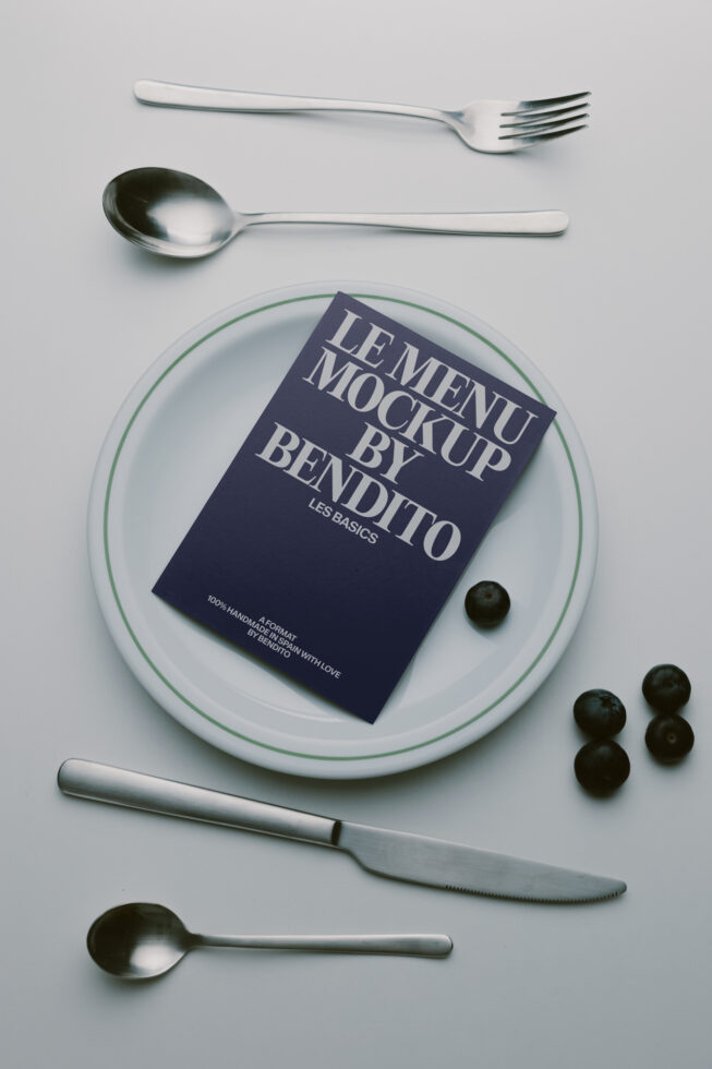 Menu mockup styled with silverware, plate, olives on minimal gray backdrop