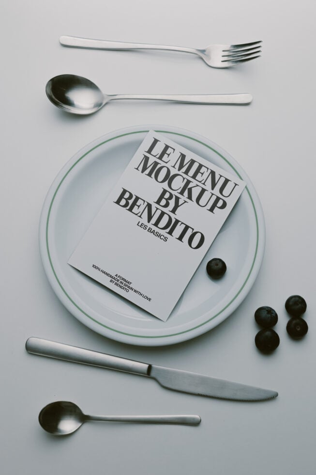 Menu mockup styled flat lay with plate, silverware, olives, minimalist food photography setup