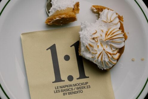 Napkin mockup displayed on white plate with cream puffs, showing typography design