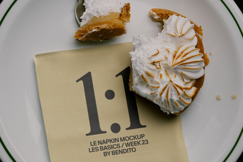 Napkin mockup displayed on white plate with cream puffs, showing typography design