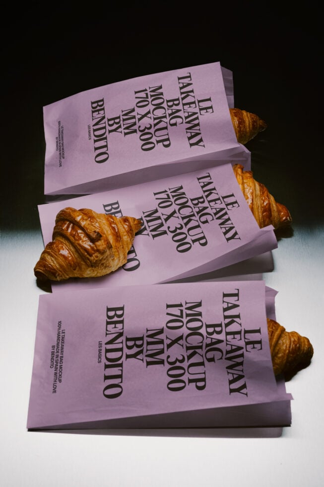 Stacked lavender takeaway bags with croissants, mockup template for bakery branding