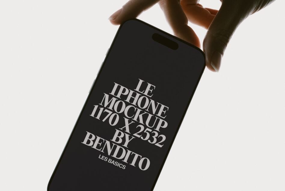 Hands holding iPhone 11 with black screen displaying serif typography mockup layout
