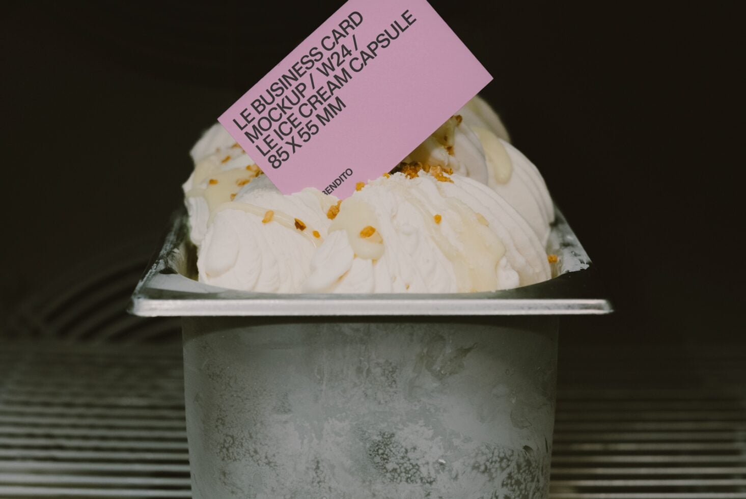 Pink business card mockup draped on ice cream cup with concrete texture