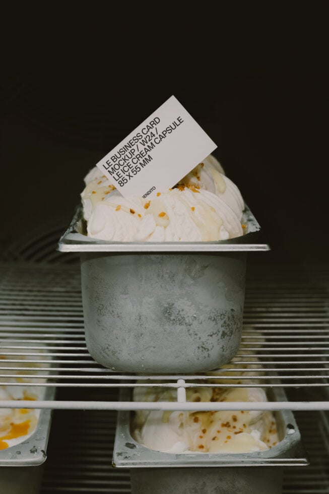 Cream ice cream in concrete cup with tilted business card label mockup