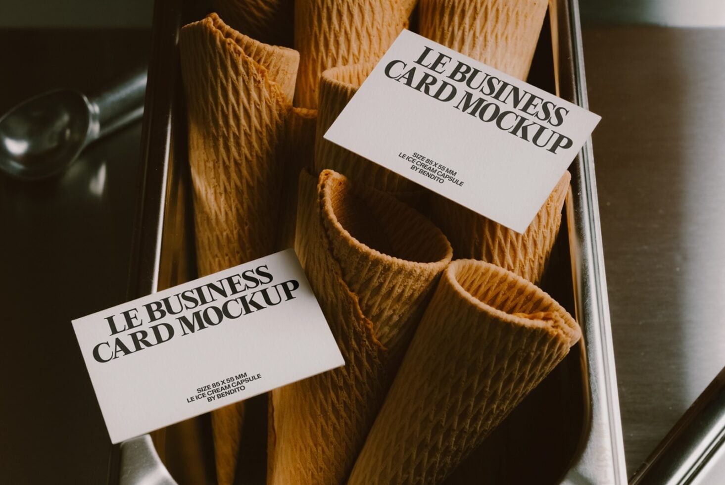 Business cards draped over textured wooden vases in a styled flat lay setup