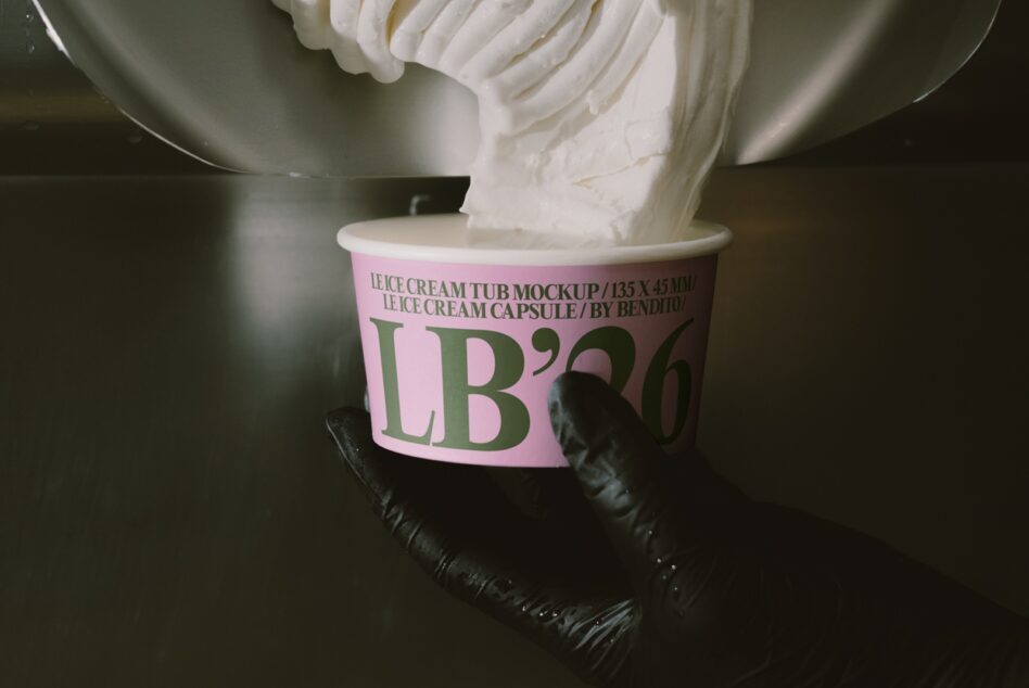 Ice cream tub mockup with pink label being held by gloved hands pouring product