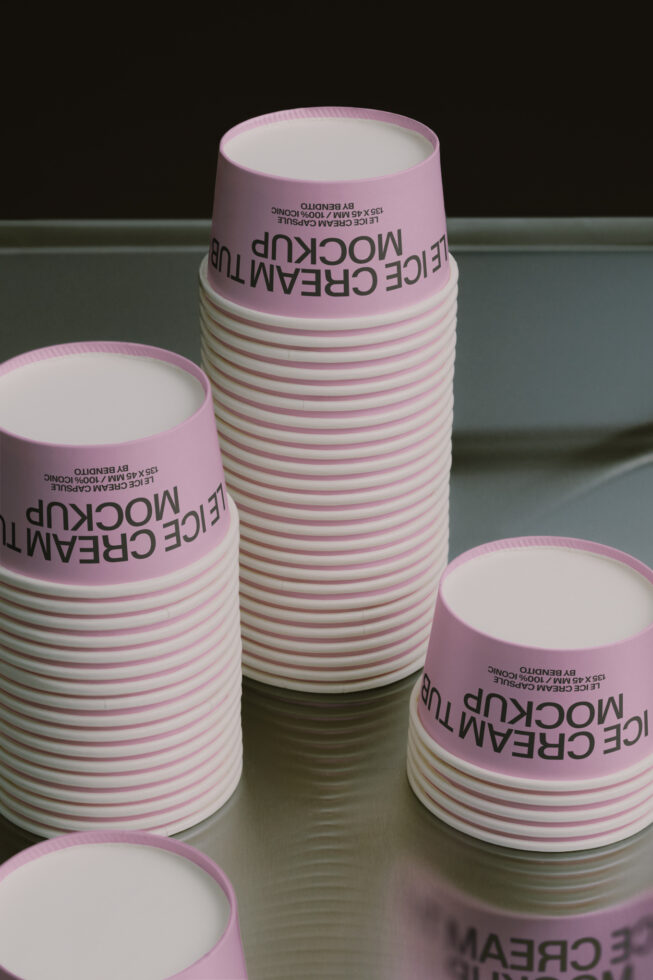 Stacked pink paper cups with custom label mockup showing text wrapping around the cylinder