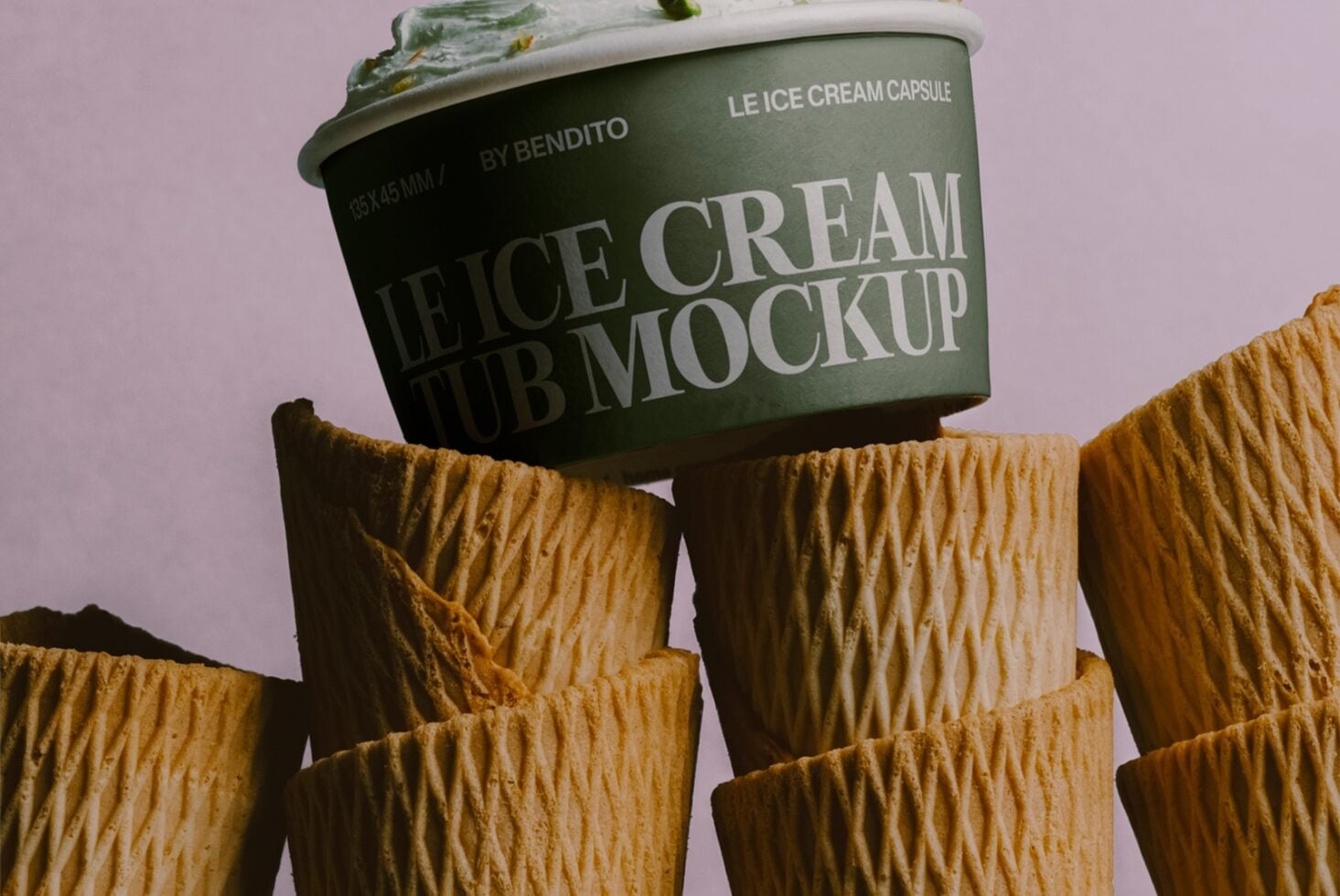 Green ice cream tub mockup balanced on waffle cones with pistachio topping