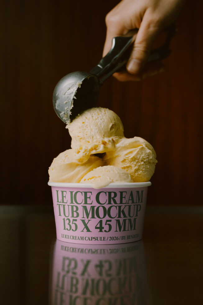 Hand scooping vanilla ice cream from pink paper cup mockup with dark moody background