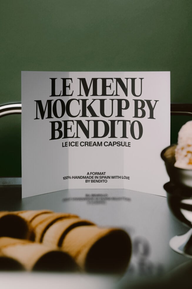 Folded menu card mockup with bold serif typography on sage green background with styling props