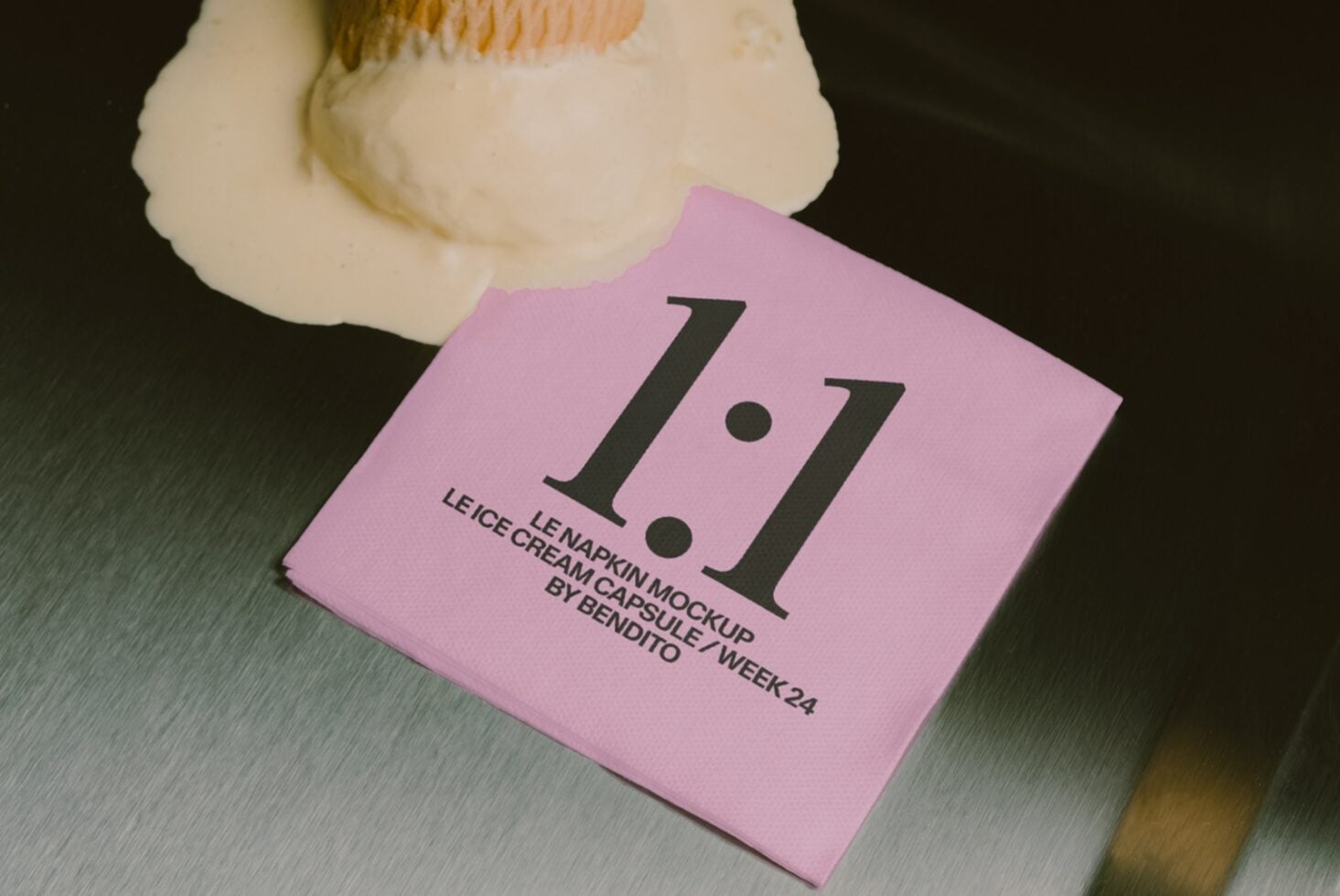 Folded pink napkin mockup with large serif numbers, cream container beside it on textured surface