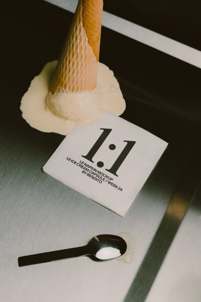 Napkin mockup with paint brush applying cream, black spoon holding sample below