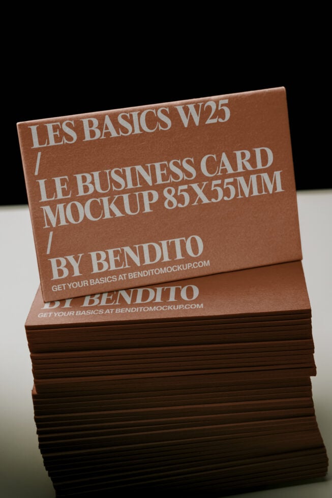 Stacked tan business cards with embossed typography showing Les Basics branding on kraft cardstock