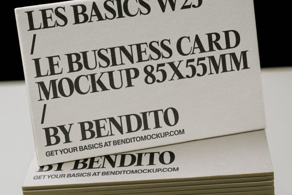 Stacked business cards with serif typography showing 85x55mm mockup dimensions on cream stock