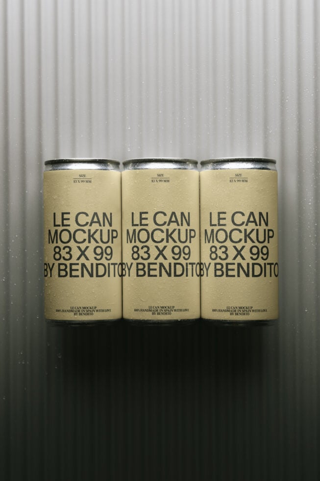 Three cream-colored tall cans with metallic tops against corrugated backdrop mockup